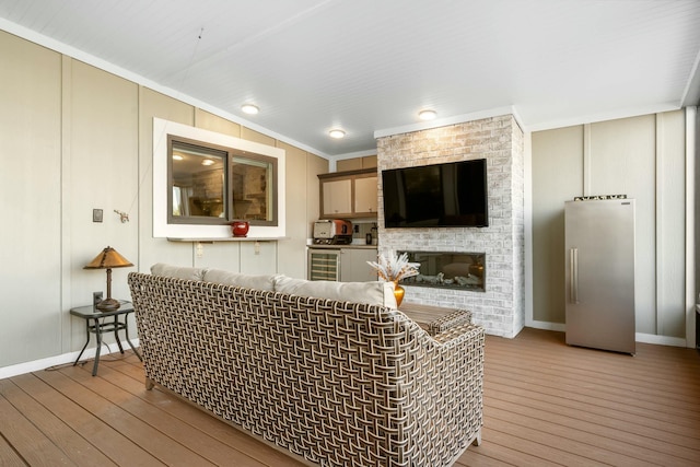 17346 Keystone Rd, Sugarloaf, FL 33042 - living room with wood-type flooring, baseboards, ornamental molding, and wine cooler