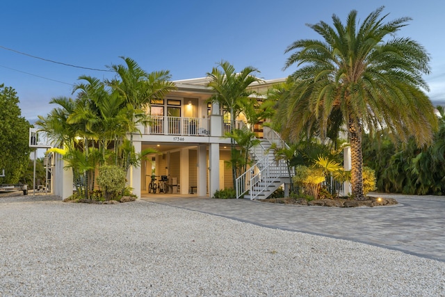 17346 Keystone Rd, Sugarloaf, FL 33042 - view of front of property with a carport, gravel driveway, a porch, and stairway