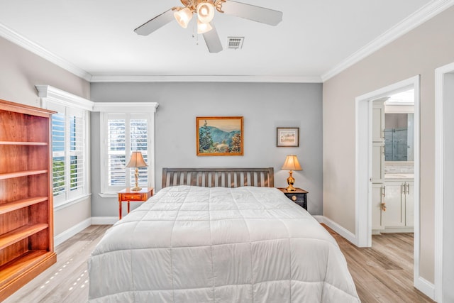 bedroom with visible vents, wood finished floors, baseboards, and ornamental molding