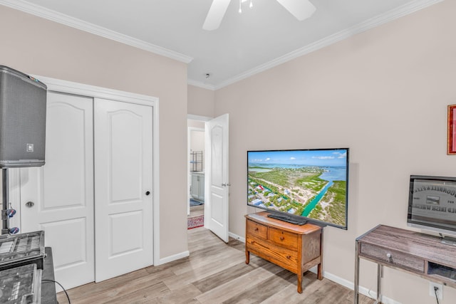 interior space with crown molding, a ceiling fan, light wood-type flooring, and baseboards