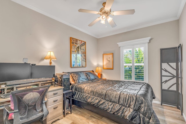 bedroom with crown molding, a ceiling fan, light wood-type flooring, and baseboards