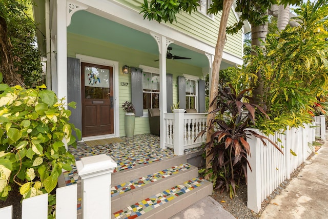 doorway to property with ceiling fan and a porch