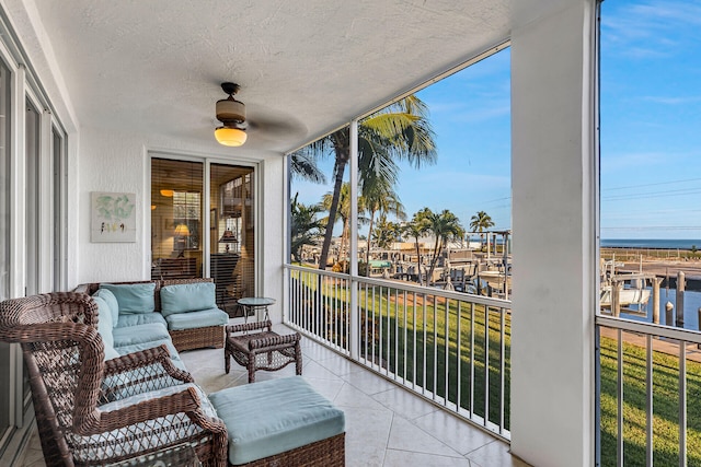 sunroom / solarium featuring a water view