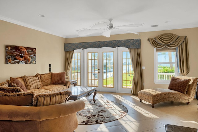 living room with light tile patterned flooring, ornamental molding, ceiling fan, and french doors