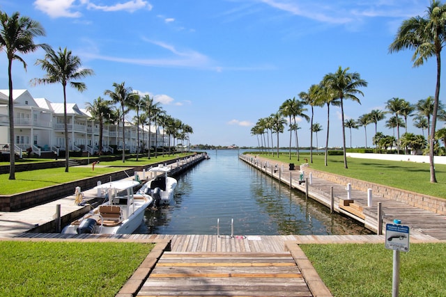 dock area featuring a lawn and a water view