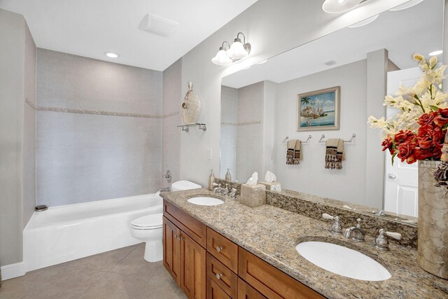 full bathroom featuring tiled shower / bath, tile patterned floors, toilet, and vanity