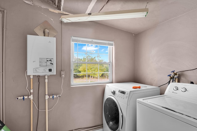 laundry area with separate washer and dryer and tankless water heater