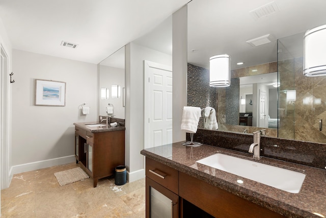 bathroom featuring vanity and a shower with door