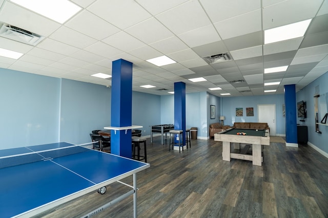 recreation room featuring a drop ceiling and dark hardwood / wood-style flooring