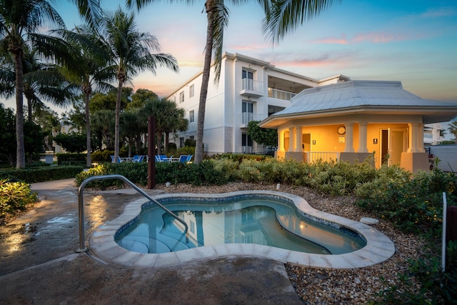 view of pool at dusk