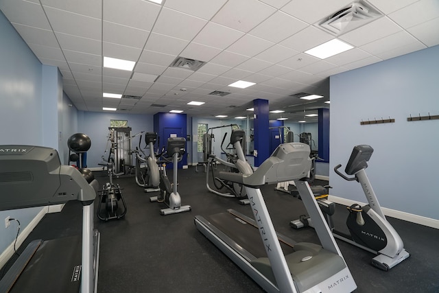 gym with a paneled ceiling