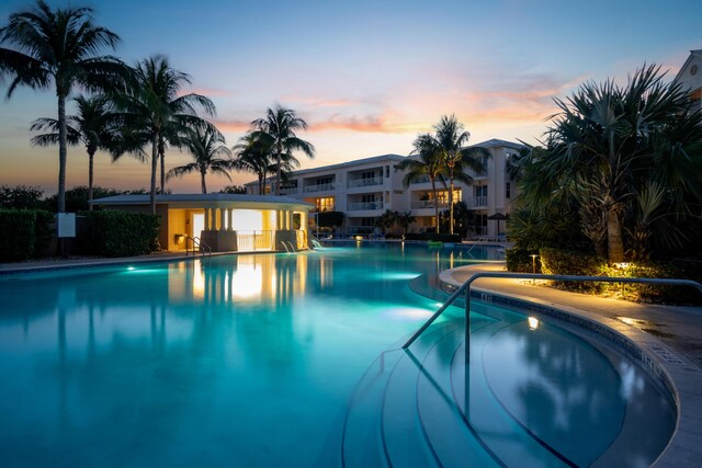 view of pool at dusk