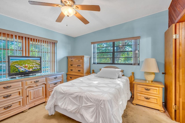 bedroom featuring a ceiling fan and light colored carpet