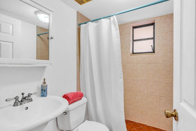 bedroom featuring multiple windows and light tile patterned floors