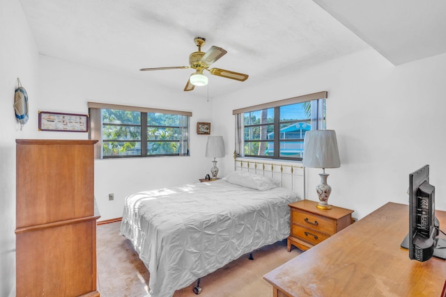 bedroom featuring light colored carpet and ceiling fan