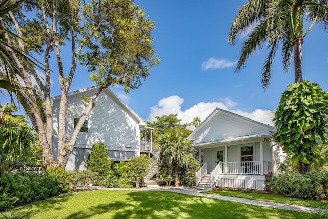 view of front of home with a front yard and covered porch