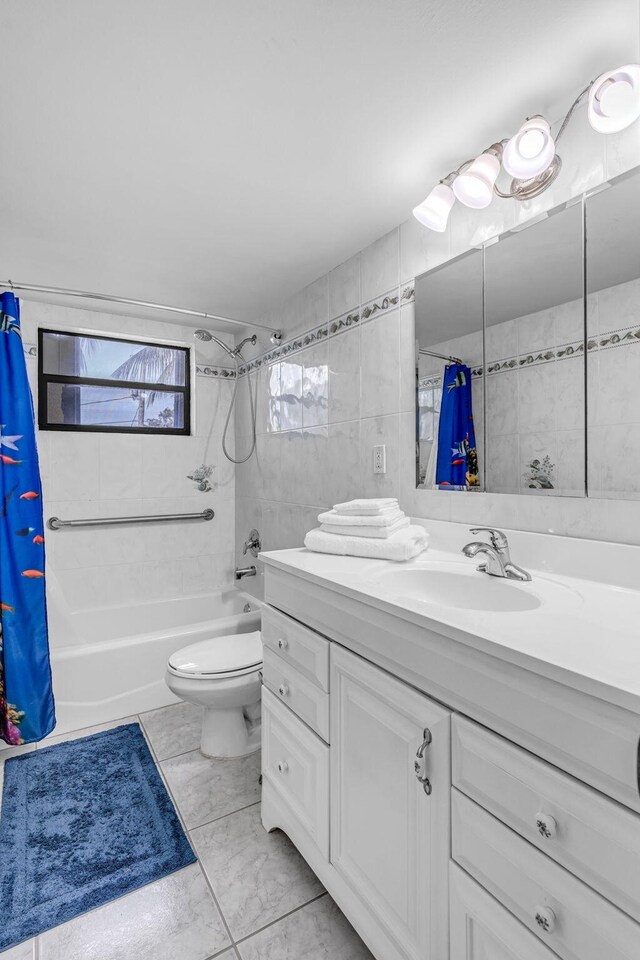 full bathroom with vanity, tile walls, shower / tub combo, and toilet