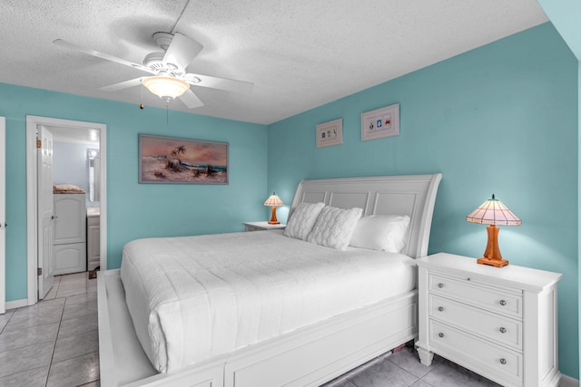 bedroom featuring ceiling fan, light tile patterned floors, ensuite bathroom, and a textured ceiling