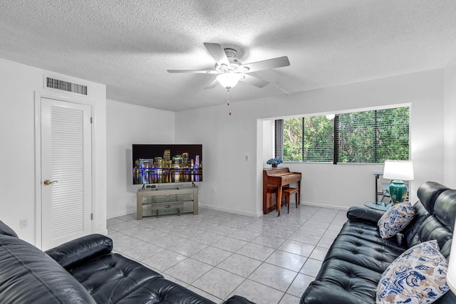 tiled living room featuring a textured ceiling and ceiling fan