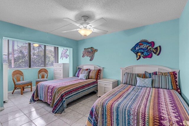 tiled bedroom featuring ceiling fan and a textured ceiling