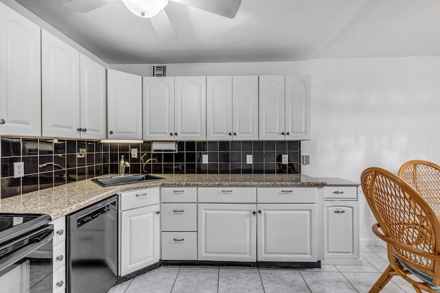 kitchen featuring white cabinetry, sink, dark stone countertops, and black appliances