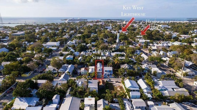 birds eye view of property with a water view and a residential view