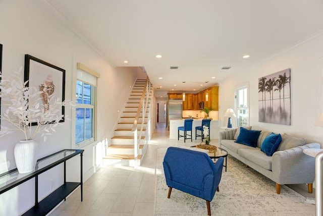 living area with recessed lighting, visible vents, and stairs