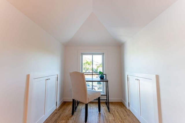 office featuring light wood-type flooring, baseboards, and vaulted ceiling