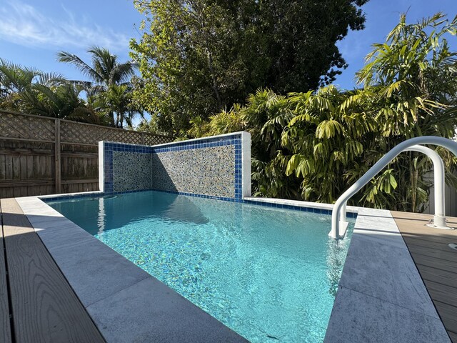 view of swimming pool featuring fence and a fenced in pool