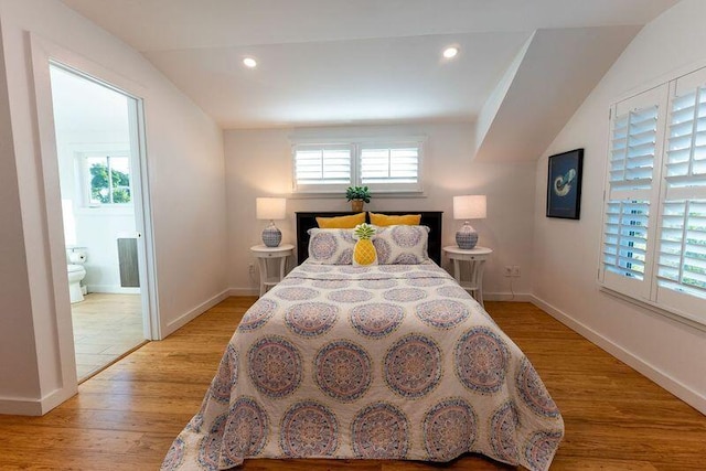 bedroom featuring recessed lighting, baseboards, ensuite bathroom, and light wood-style floors