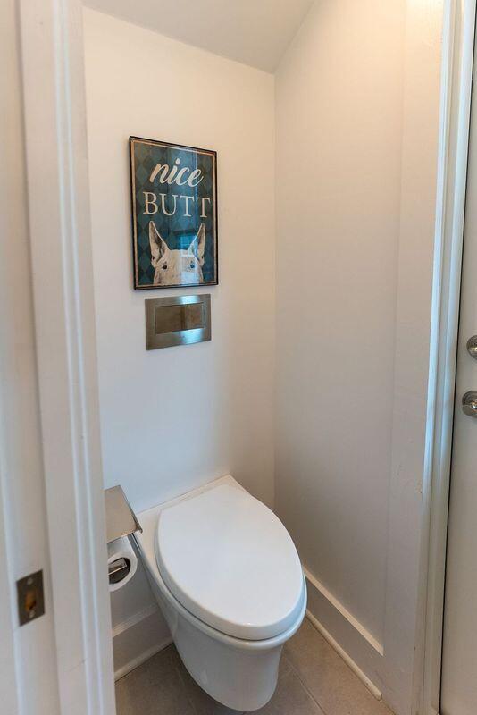 bathroom featuring tile patterned flooring, toilet, and baseboards