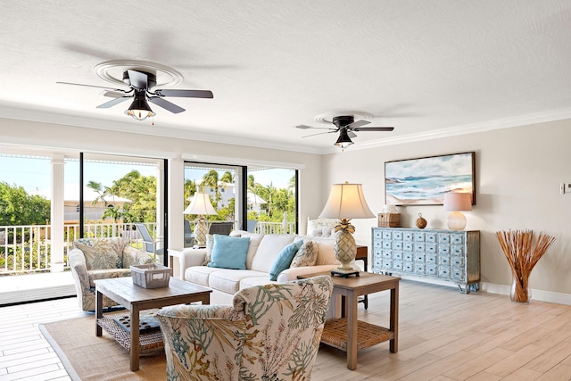 living room with crown molding, ceiling fan, a healthy amount of sunlight, and light hardwood / wood-style floors