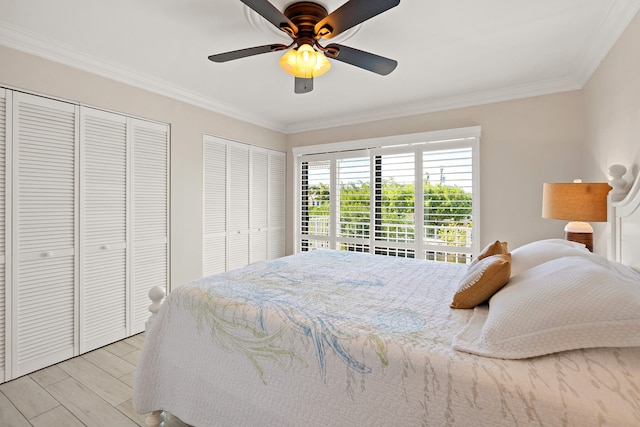 bedroom featuring multiple closets, ceiling fan, crown molding, and light hardwood / wood-style floors