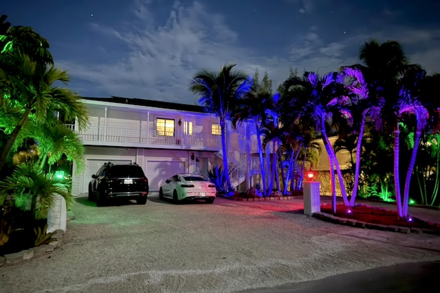 view of front facade with a garage and a balcony