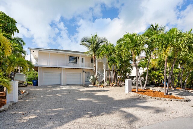 view of front of property featuring a garage and a balcony