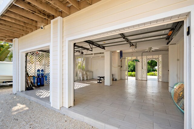 garage featuring ceiling fan and a garage door opener