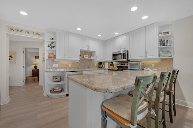 18 Anchor Dr Unit B, Key Largo, FL 33037 - kitchen with open shelves, white cabinets, baseboards, and stainless steel appliances