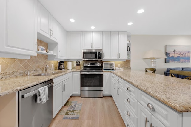 18 Anchor Dr Unit B, Key Largo, FL 33037 - kitchen featuring stainless steel appliances, a peninsula, a toaster, a sink, and open shelves