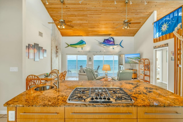 kitchen with ceiling fan, sink, stainless steel gas cooktop, and wooden ceiling