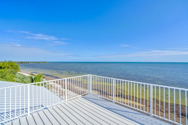 wooden terrace featuring a water view