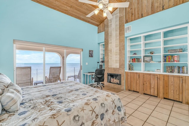 bedroom with high vaulted ceiling, a water view, light tile patterned flooring, a tiled fireplace, and wooden ceiling