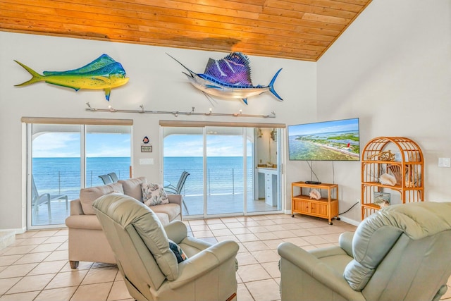 living room with a water view, a healthy amount of sunlight, light tile patterned floors, and wooden ceiling