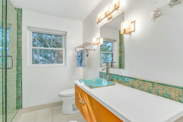 bathroom with tile patterned flooring, an enclosed shower, vanity, and toilet