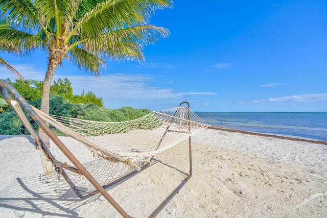 surrounding community featuring a water view and a view of the beach