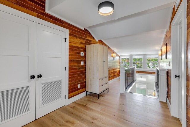 1114 Grinnell St, Key West, FL 33040 - hall featuring an upstairs landing, vaulted ceiling, wooden walls, and light wood finished floors