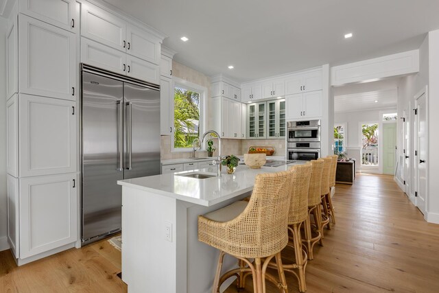 1114 Grinnell St, Key West, FL 33040 - kitchen with appliances with stainless steel finishes, healthy amount of natural light, white cabinetry, light wood-style floors, and recessed lighting