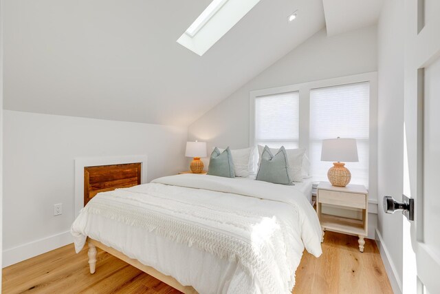 1114 Grinnell St, Key West, FL 33040 - bedroom with lofted ceiling, a skylight, and light wood-type flooring
