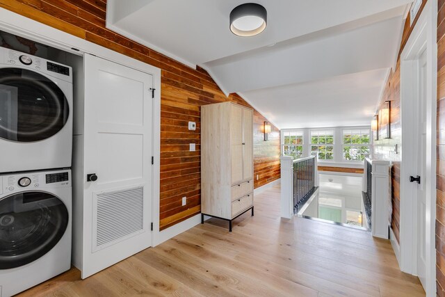 1114 Grinnell St, Key West, FL 33040 - washroom featuring stacked washer / drying machine, wooden walls, and light wood-style flooring