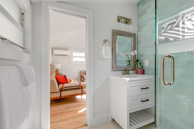 1114 Grinnell St, Key West, FL 33040 - ensuite bathroom featuring vanity, a wall mounted AC, a stall shower, and wood finished floors