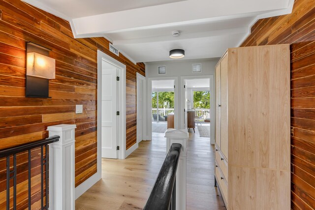 1114 Grinnell St, Key West, FL 33040 - corridor with an upstairs landing, wood walls, light wood-type flooring, and beamed ceiling